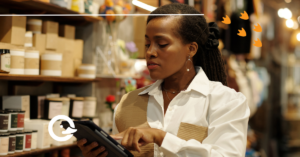 causes of margin erosion in retail represented by a retail worker looking at an ipad with a neutrally concerned look on her face in front of shelves of inventory